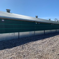 Galebreaker Bayscreen attached to the side of a shed to act as a windbreak